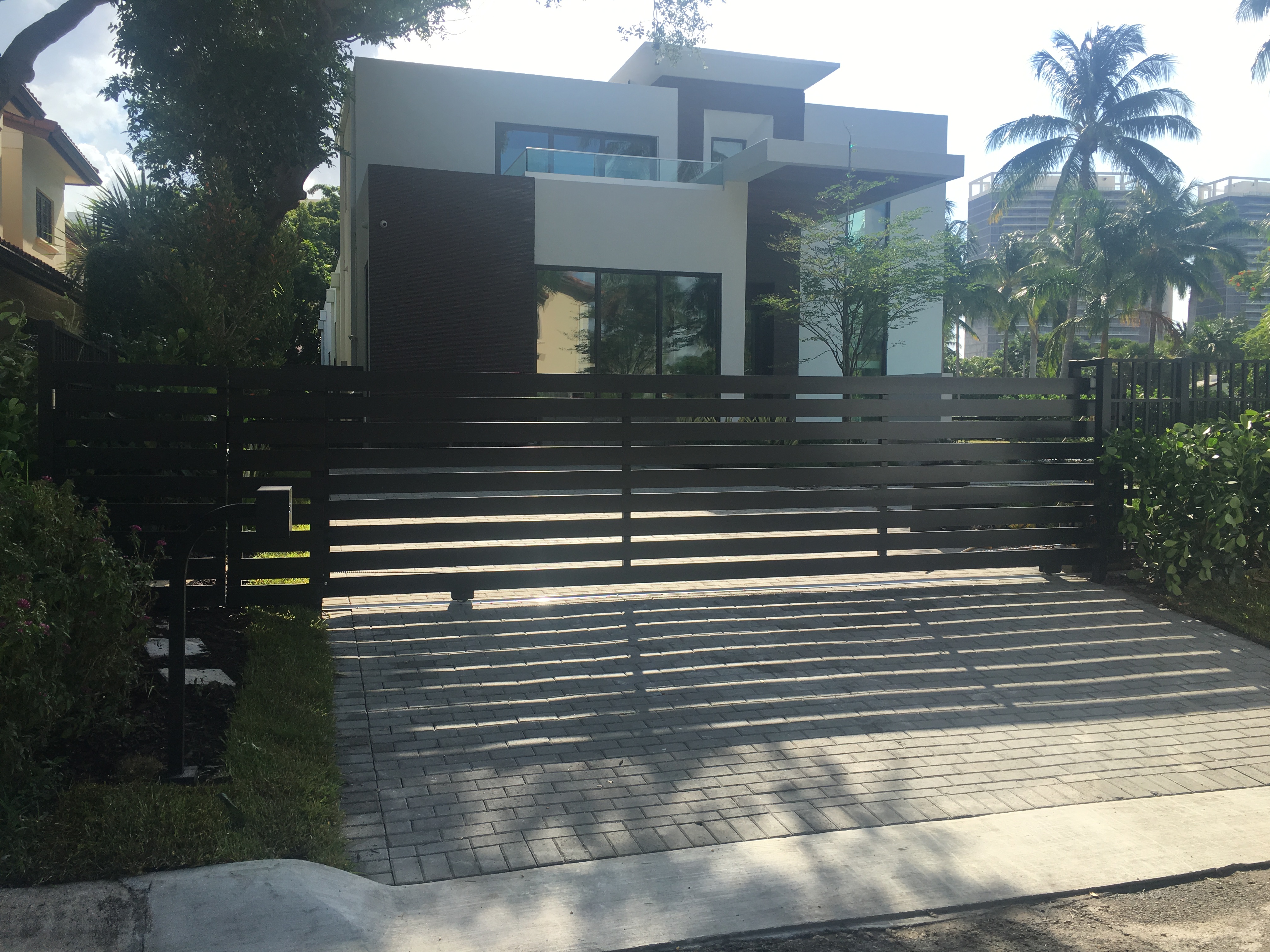 Dark Horizontal Sliding Gate with Landscaping