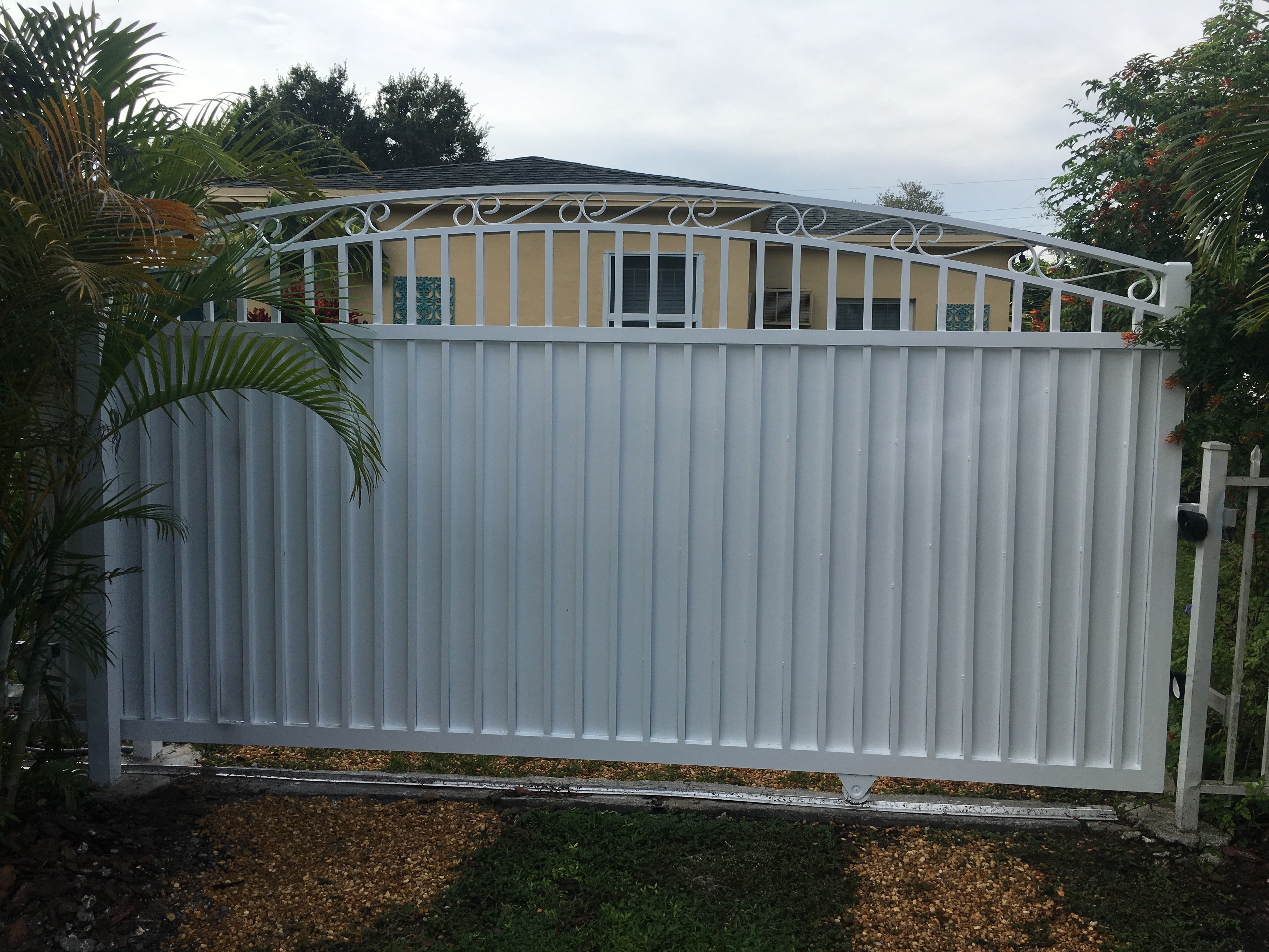 White Privacy Sliding Gate with Scroll Detail