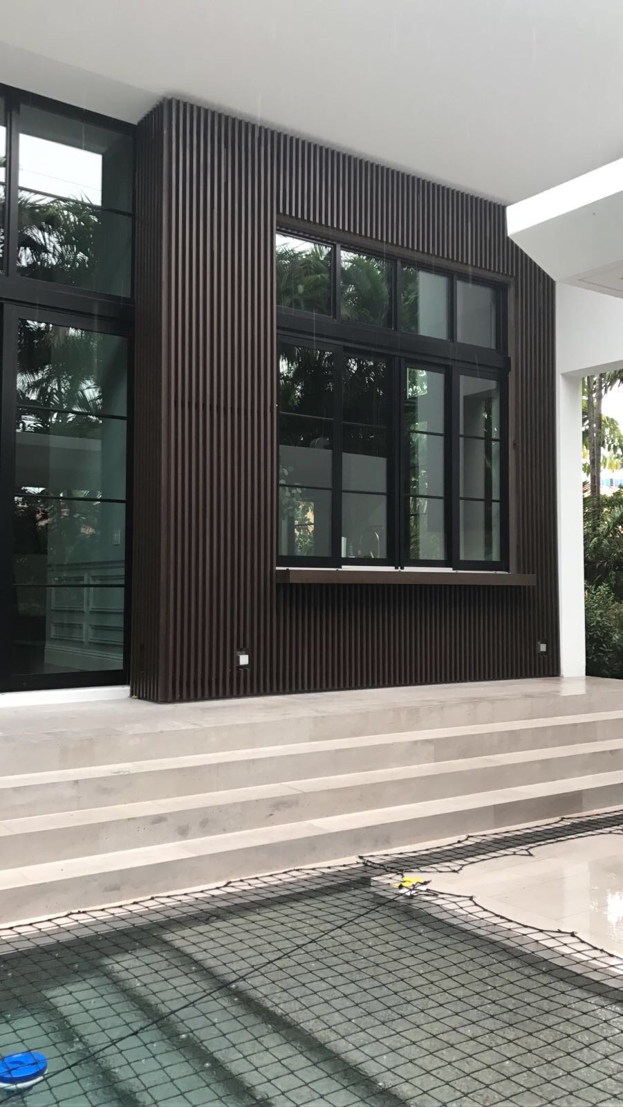 Modern Wood-Tone Aluminum Facade with Windows