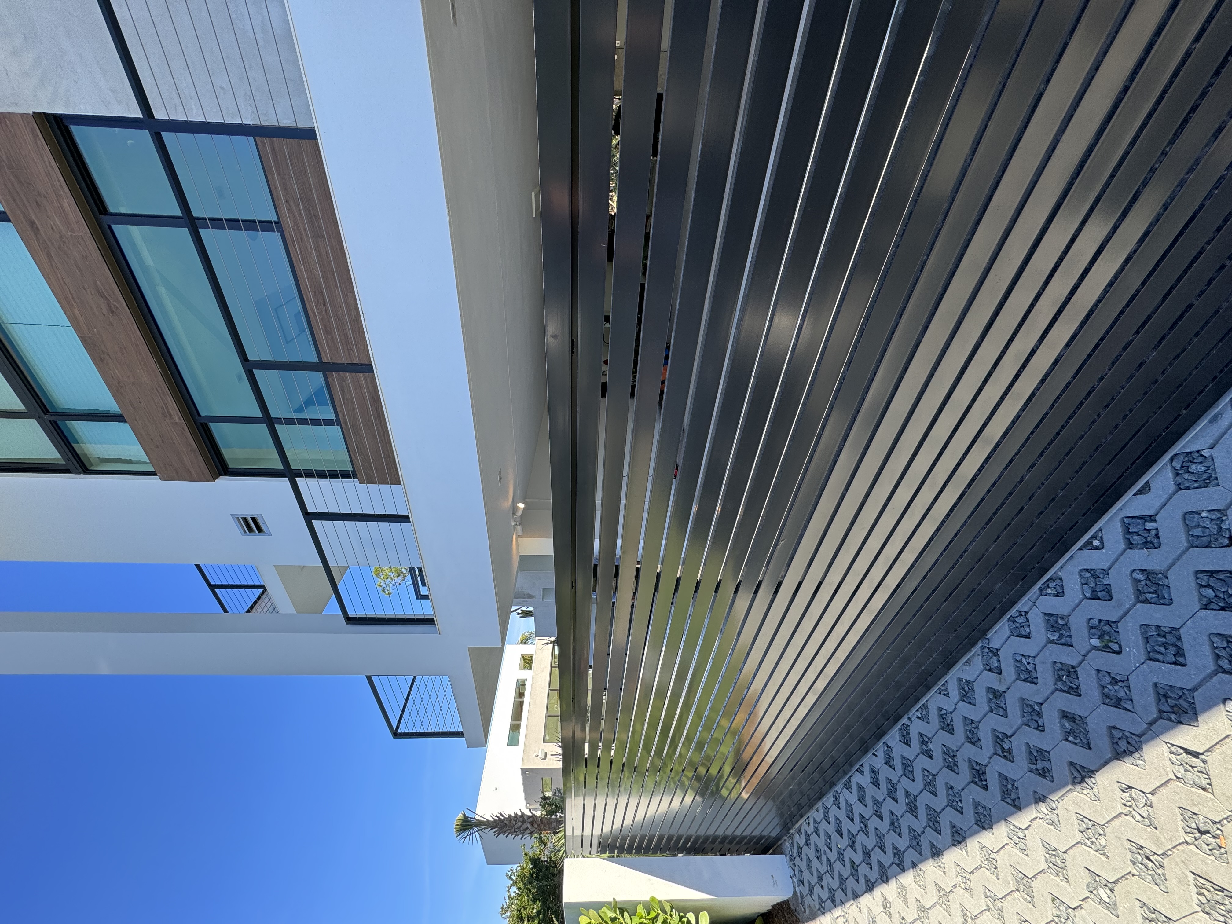 Dark Vertical Aluminum Slat Driveway Fence