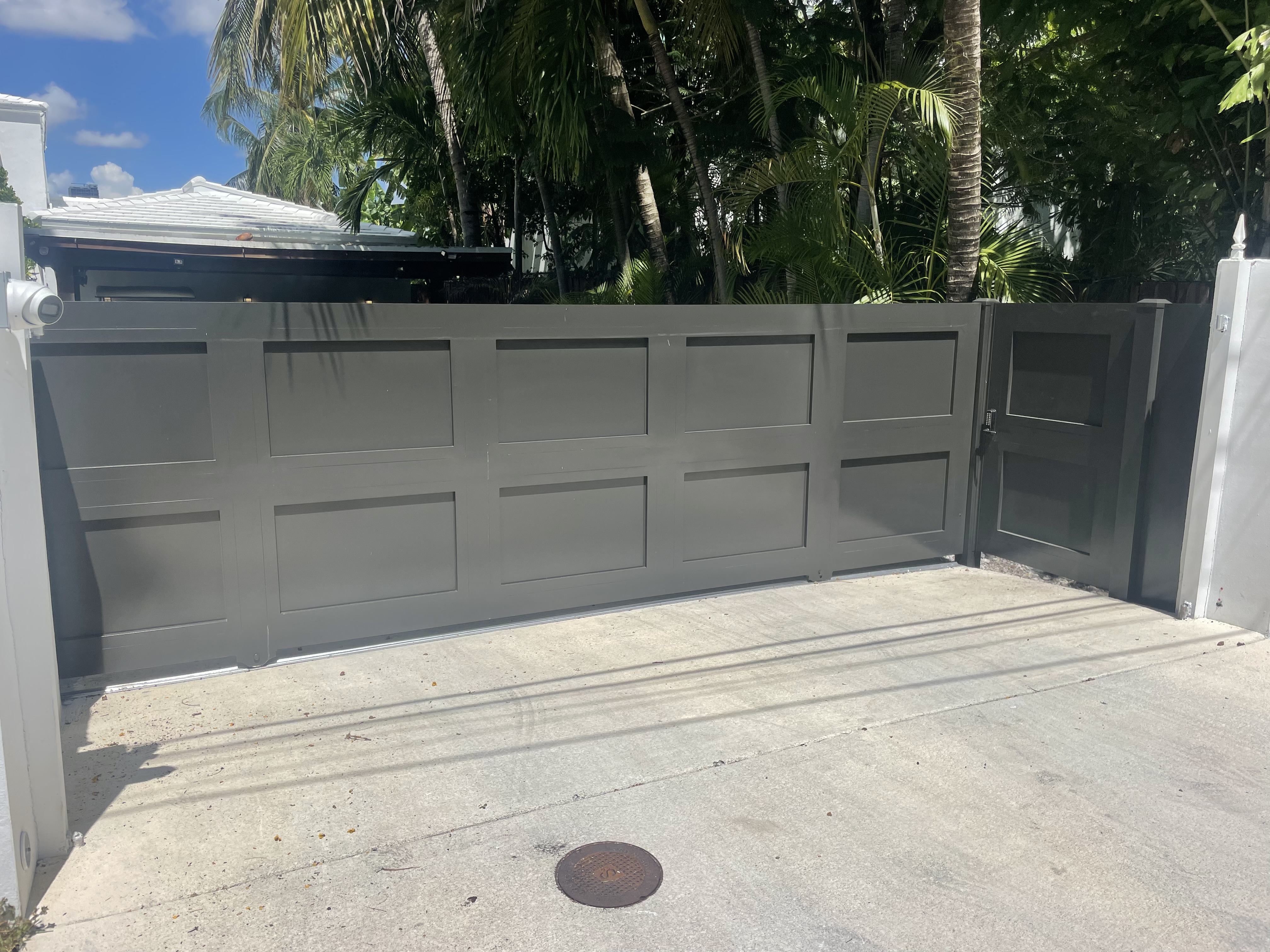Gray Panel Driveway Gate with Pedestrian Door