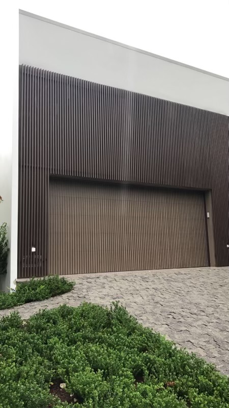 Wood-Tone Vertical Slat Garage Facade Cladding