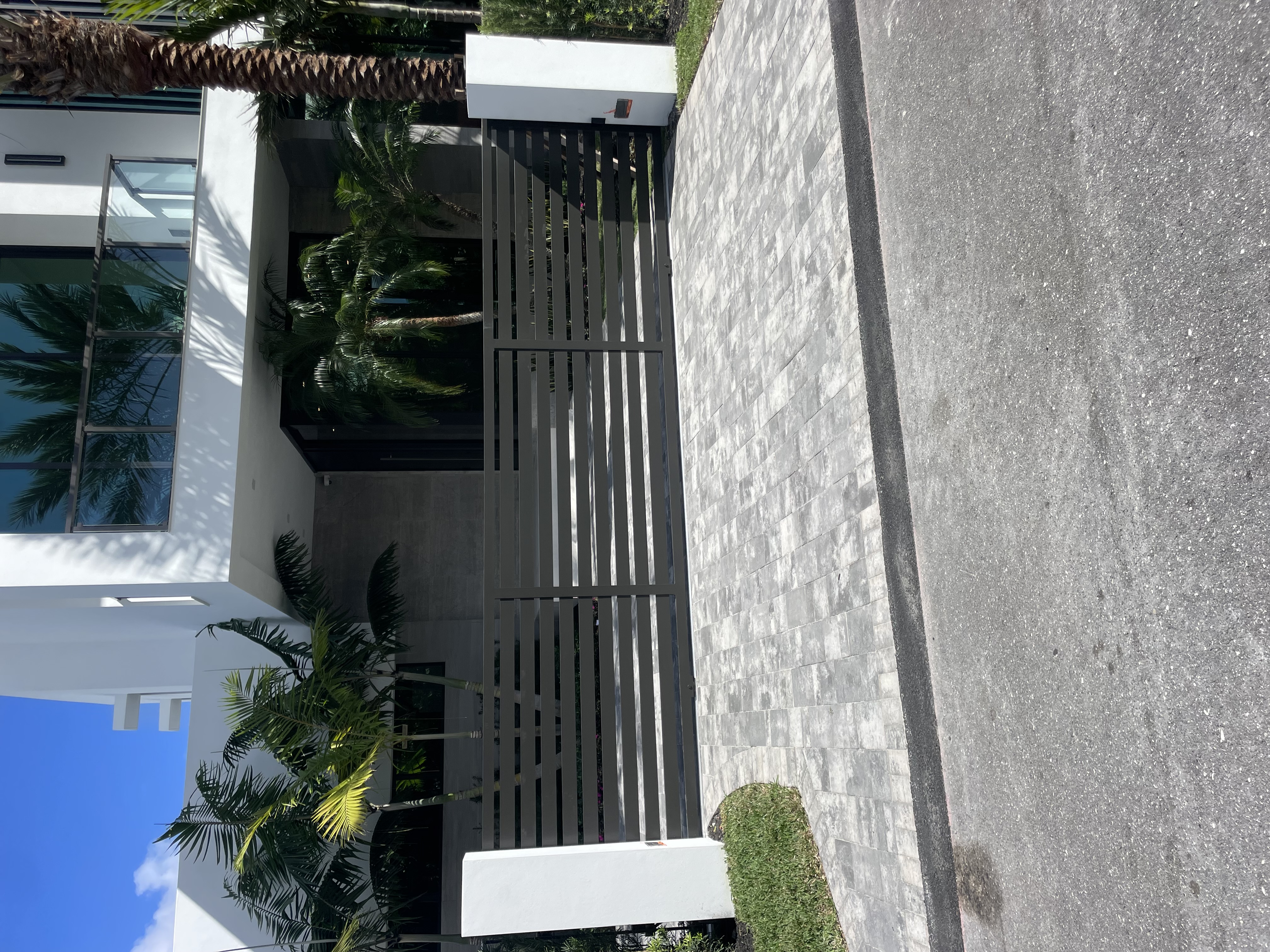 Vertical Slat Gate Side View with Stone Wall